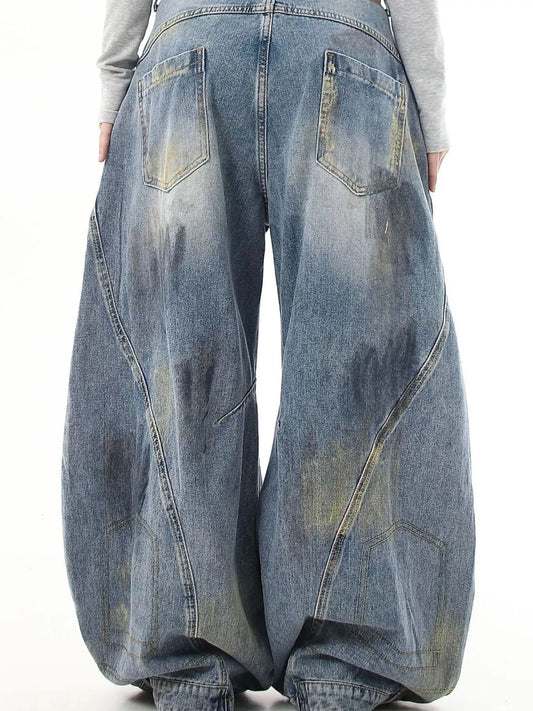 Distressed blue wide-leg jeans with back yoke stitching and large patch pockets