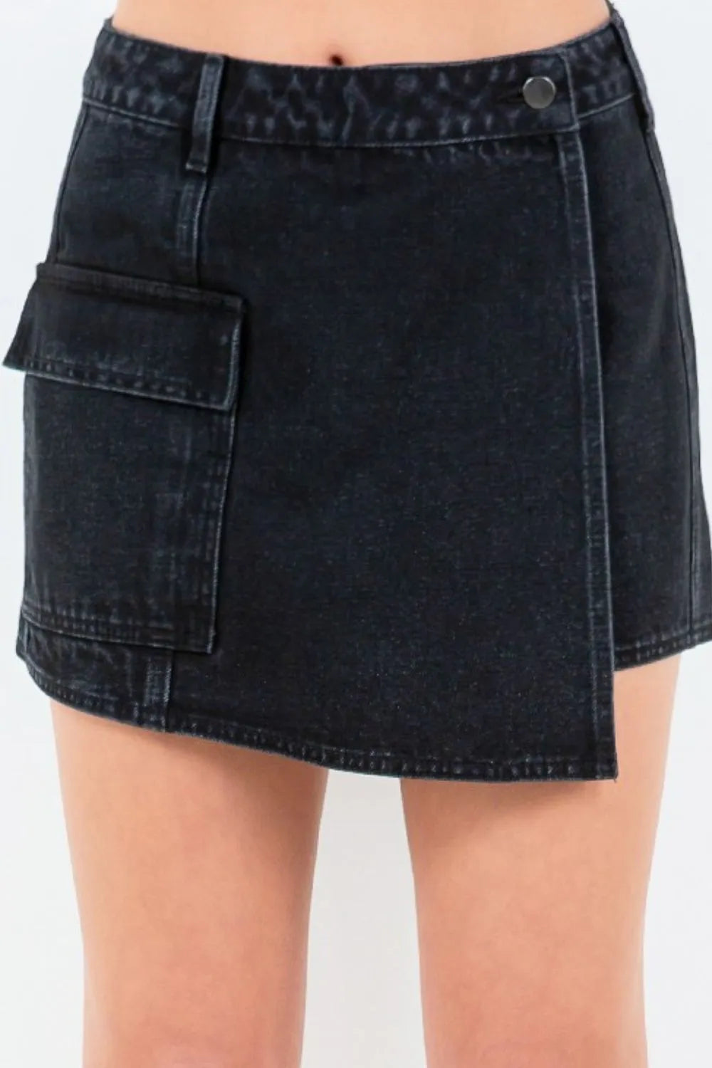 Black denim mini skort with cargo pocket on the left front, button closure at waist