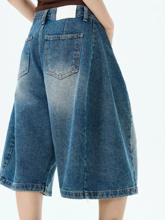 Blue wide-leg denim shorts with back patch pocket detail and wide hem