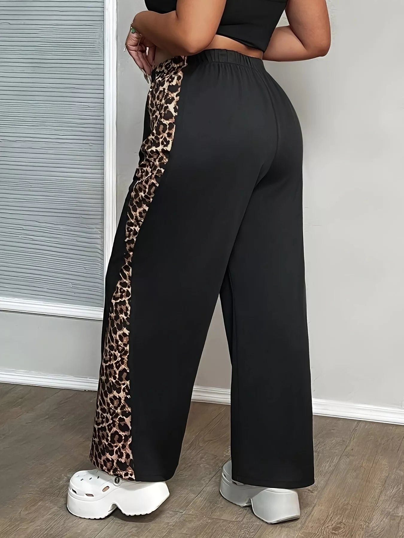 Black wide-leg pants with leopard print side trim, elastic waistband