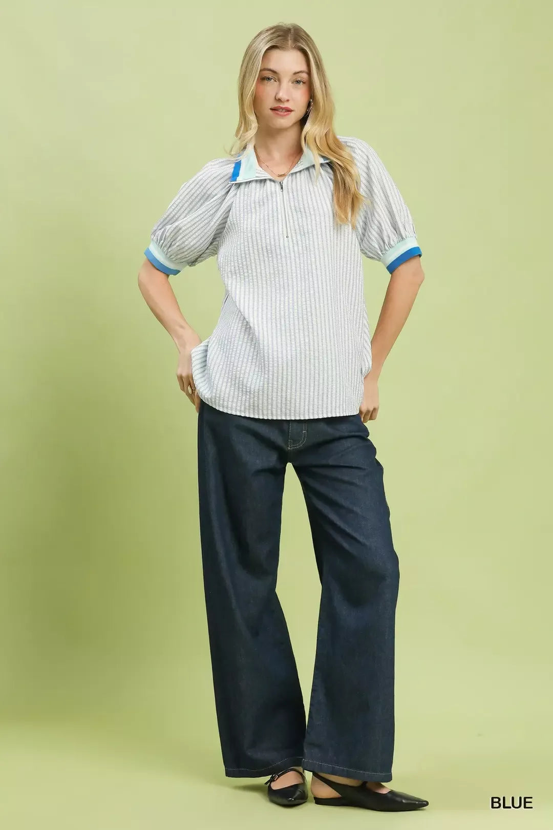 Striped puff short-sleeve blouse with blue collar and cuffs, paired with dark jeans