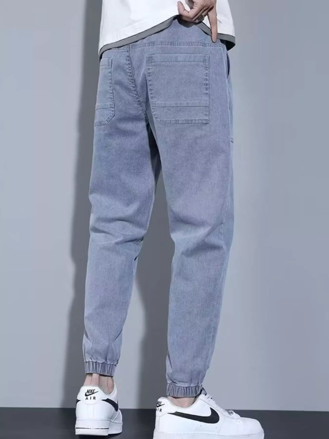 Men's grey denim joggers with back patch pockets and elastic ankle cuffs