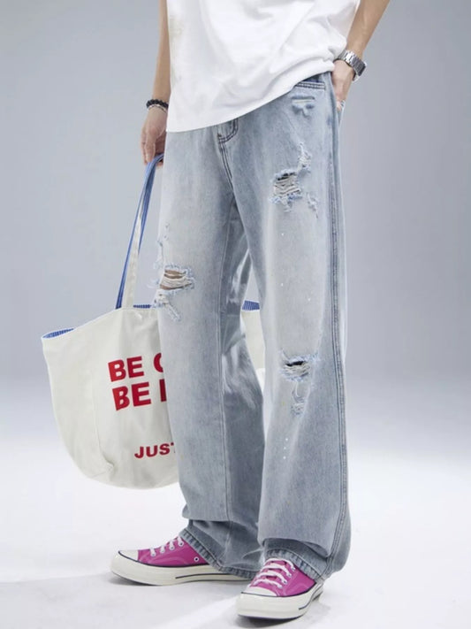 Light blue wide-leg jeans with multiple rips and frayed patches