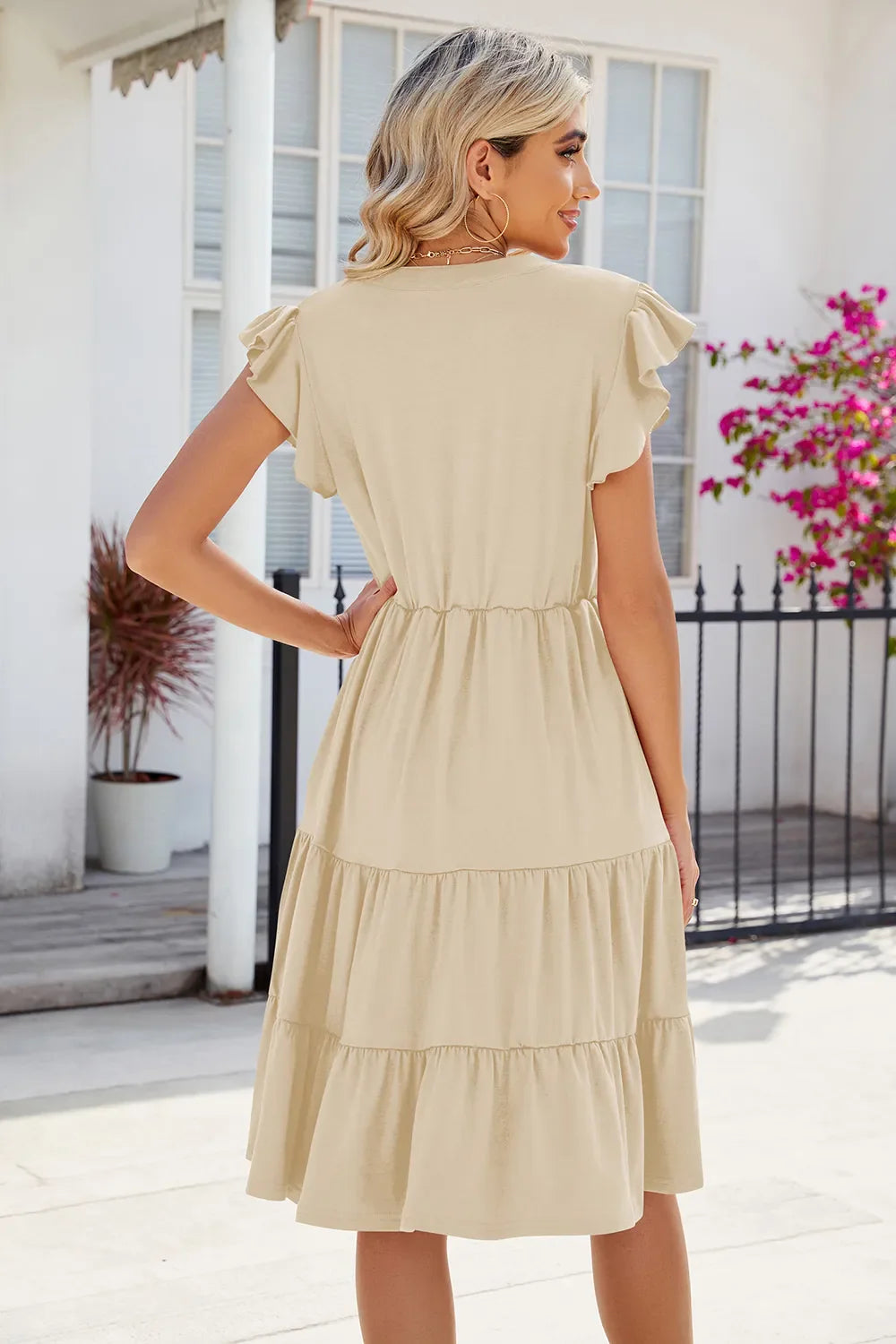 Cream tiered cap-sleeve dress with gathered waist, back view