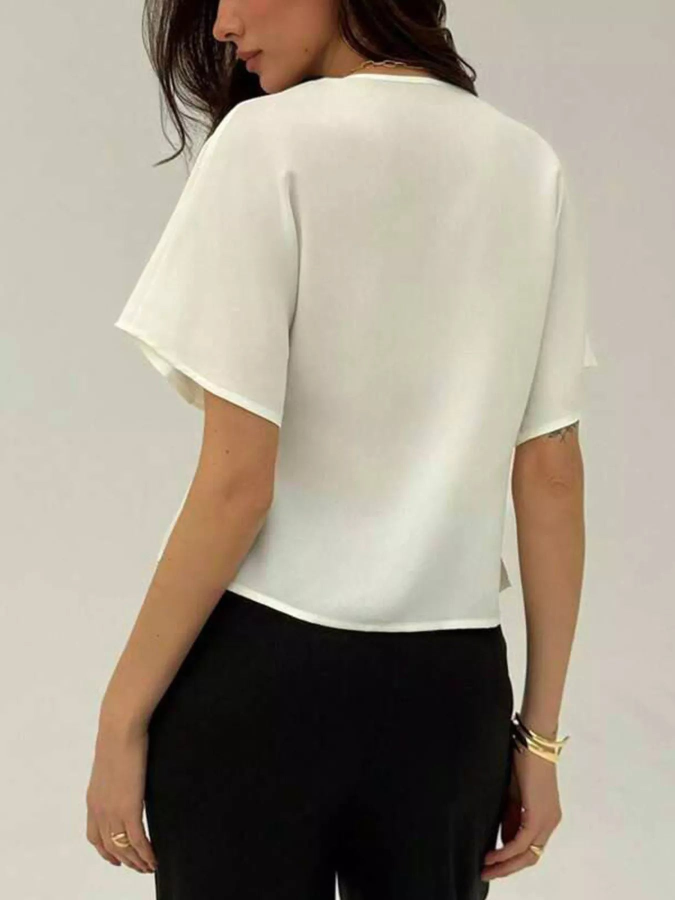 White short-sleeve V-neck button-up shirt, back view