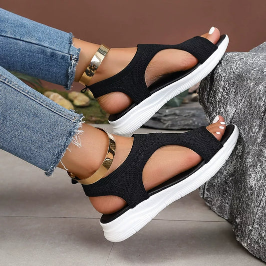 Black open-toe platform sandals with crisscross straps and white textured sole
