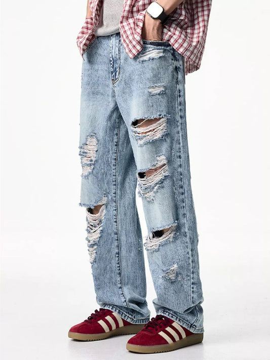 Light blue distressed wide-leg jeans with large ripped knees and frayed edges
