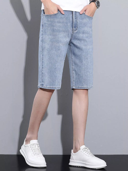 Light blue denim wash shorts on model, cuffed hem, front pockets, belt loops
