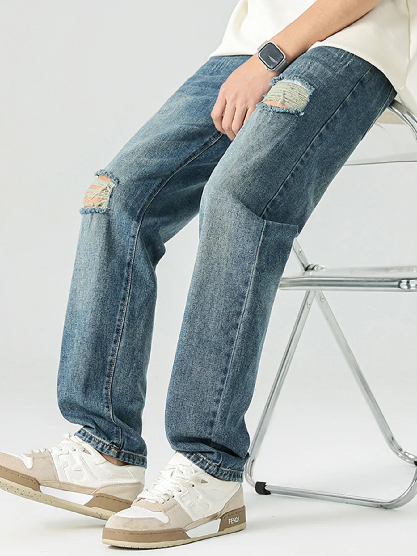 Men's distressed relaxed jeans in vintage blue, knee rips and distressed pocket