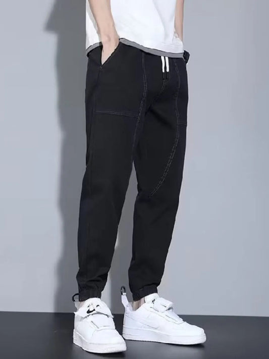 Men's black denim joggers, side and front pockets, elastic ankle cuffs
