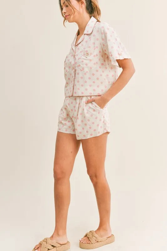 Pink polka dot collared crop top and matching lounge shorts set, standing profile