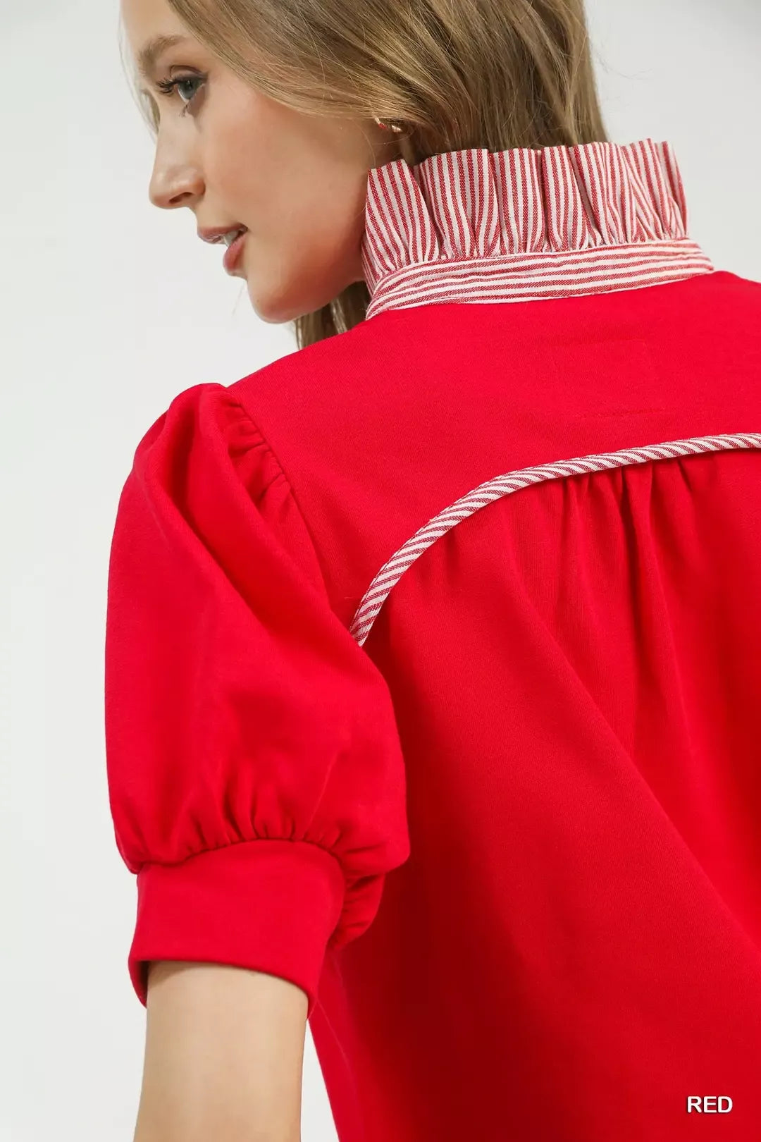 Red popover top close-up of striped collar band and puff sleeve cuff