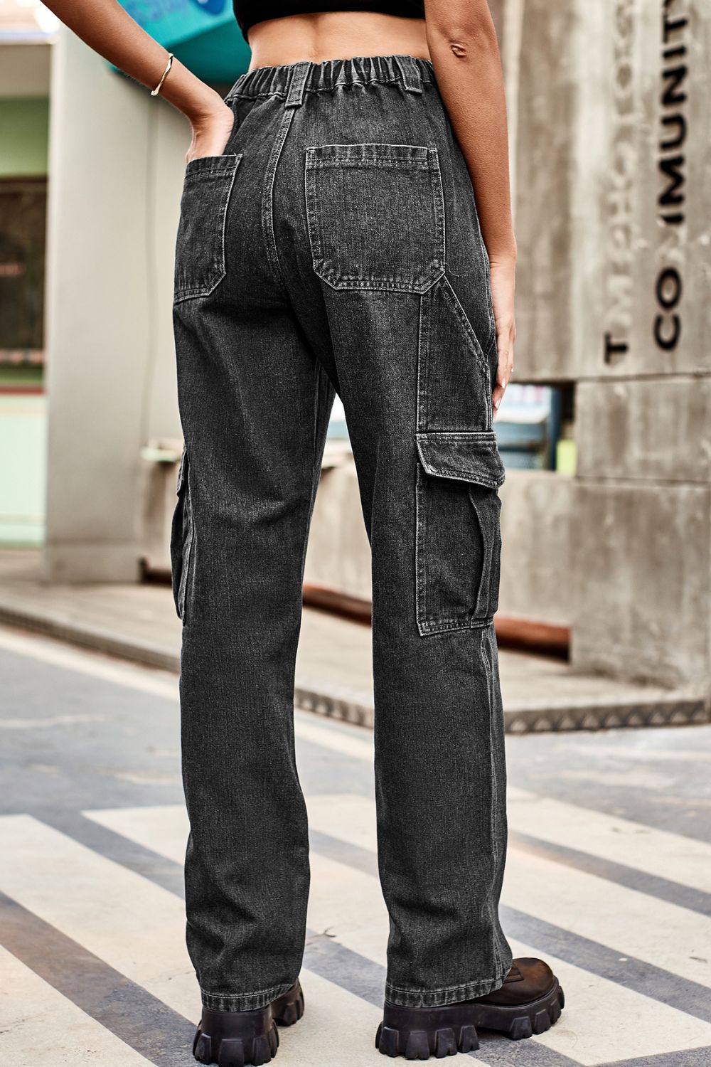 Loose-fit dark gray denim cargo pants, back view with side and back patch pockets