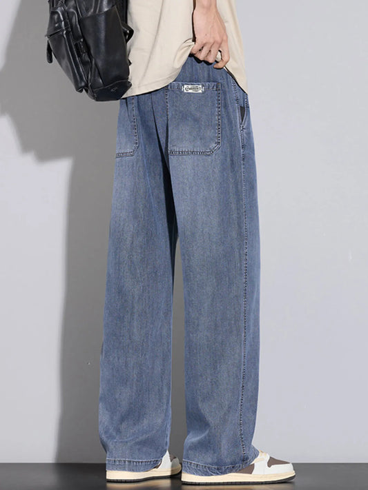 Men's wide-leg relaxed-fit jeans in medium-blue wash, front and back pockets visible