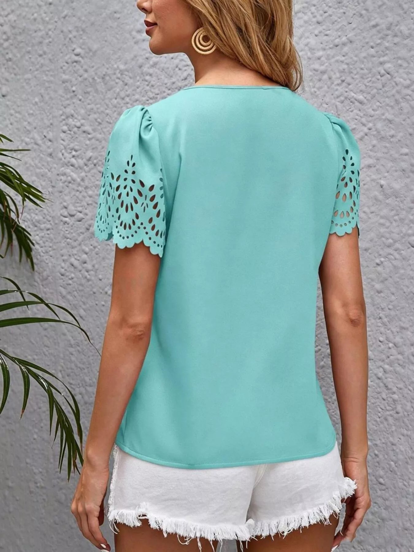 Pastel blue V-neck short sleeve blouse with lace cutout sleeves, back view
