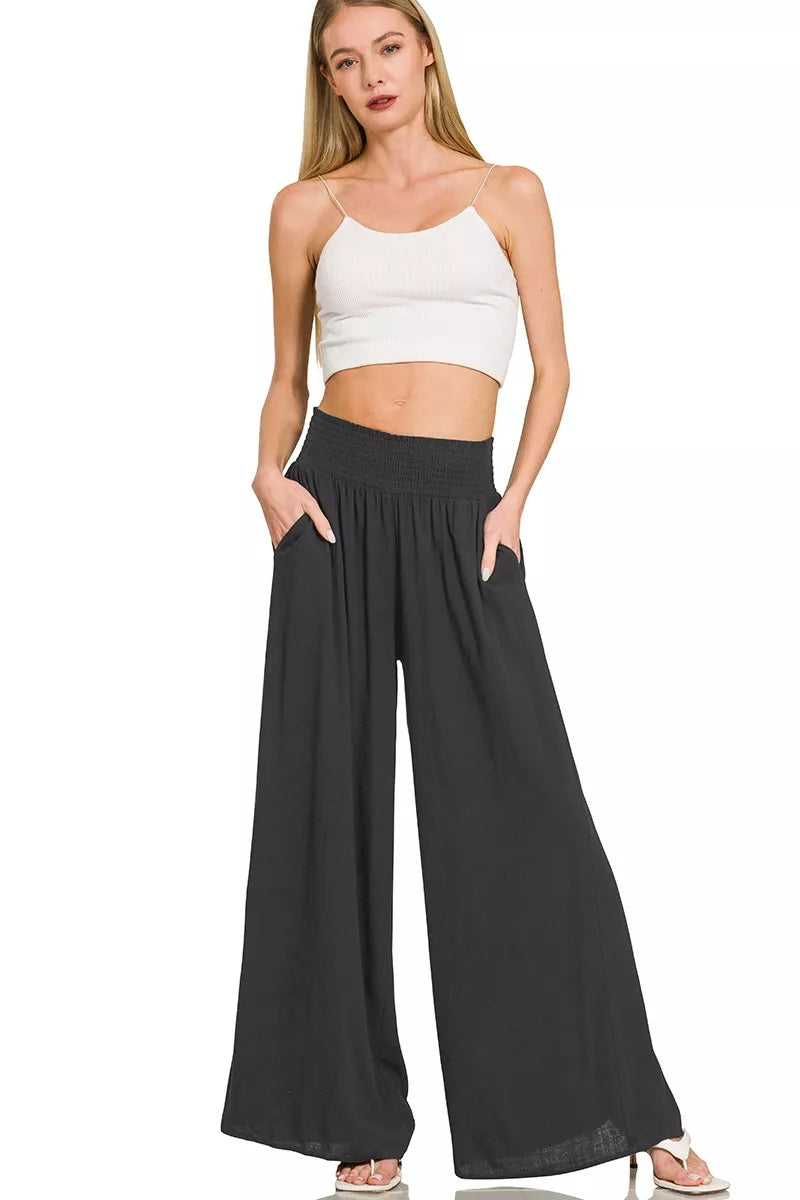 Black wide-leg lounge pants with smocked waistband and loose wide fit