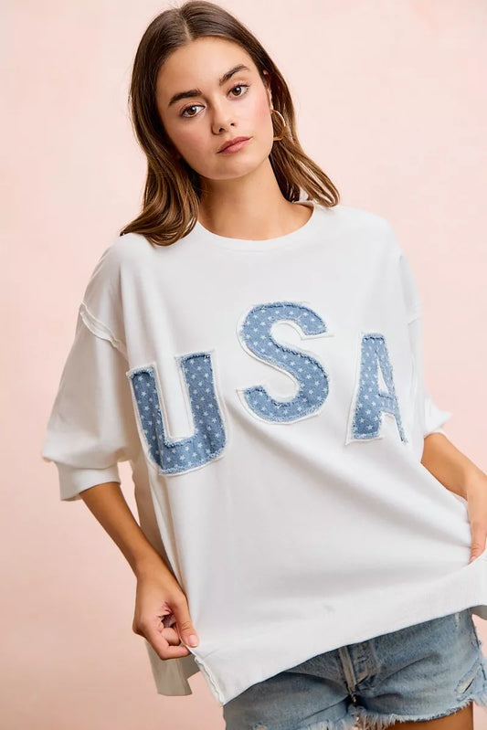 Ivory crewneck French terry top with large blue USA letter patchwork