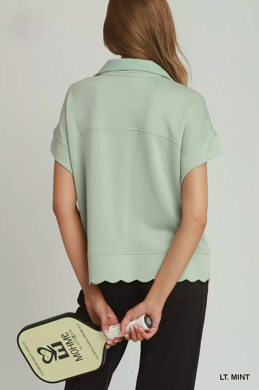 Light mint half-zip pullover back view with short sleeves and scalloped hem