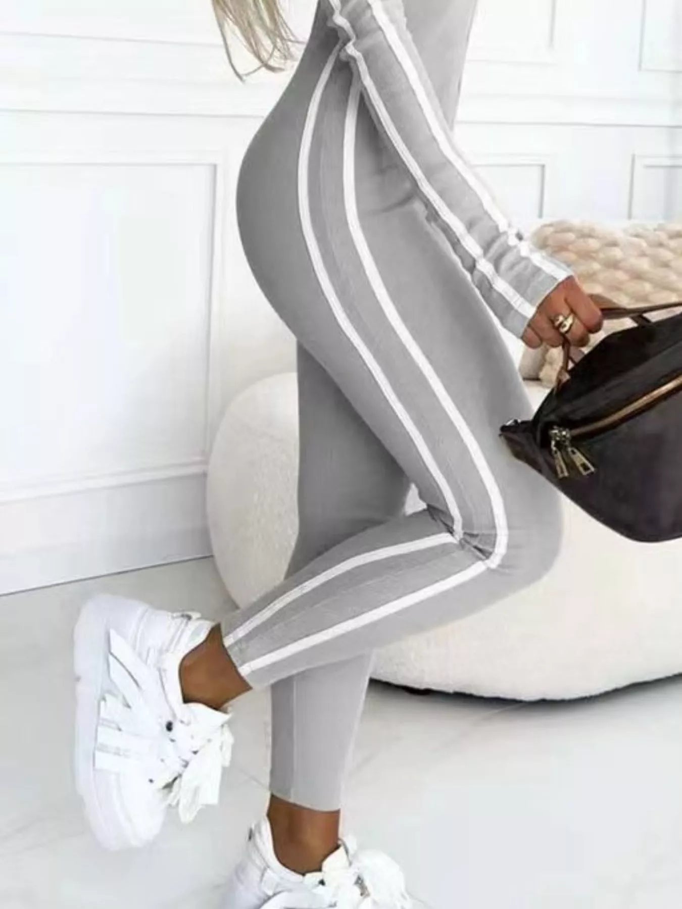 Gray zip-front long sleeve jumpsuit with white vertical stripes and cuff trim