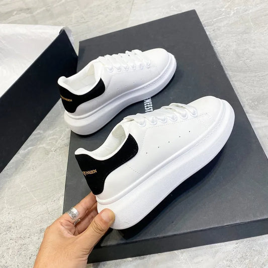 White PU lace-up platform sneakers with black side swoosh and round toe