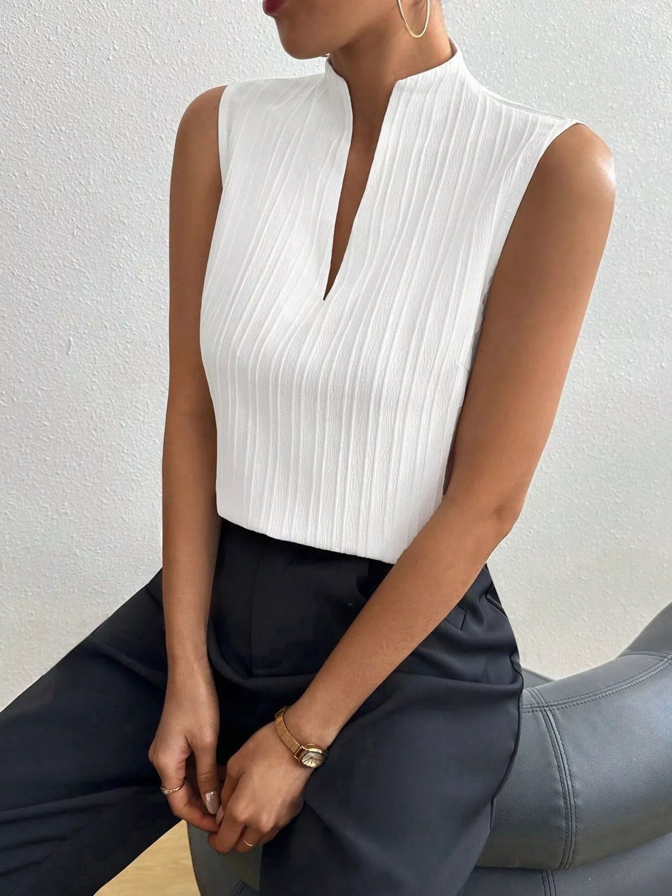 White notched sleeveless top with keyhole V front and vertical textured stripes