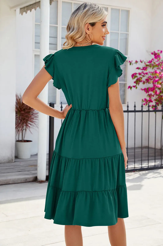 Dark green V-neck cap-sleeve tiered midi dress, back view with gathered waist