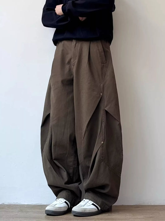 Brown loose-fit cargo pants with side flap pockets and drawstring waist