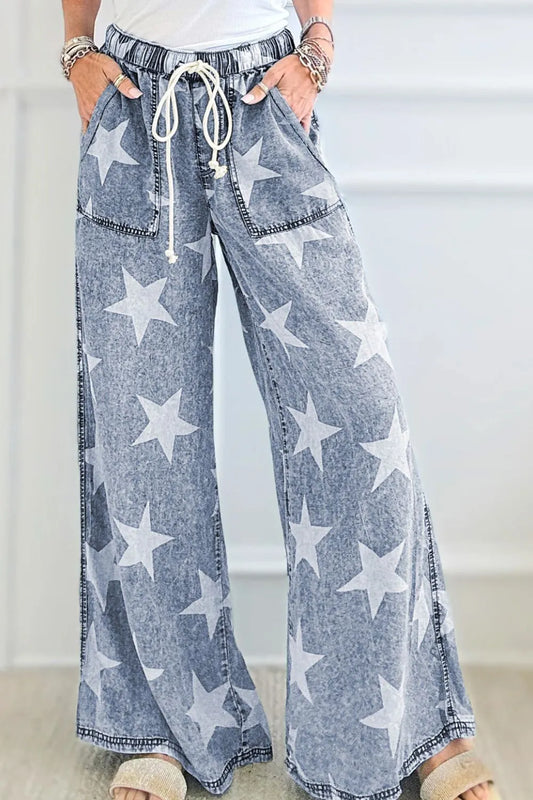 Washed blue wide-leg jeans with star print, high waist, and drawstring tie