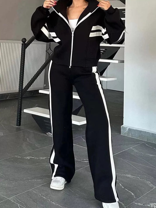 Black zip-up jacket and flared pants set with white contrast stripe and zip front
