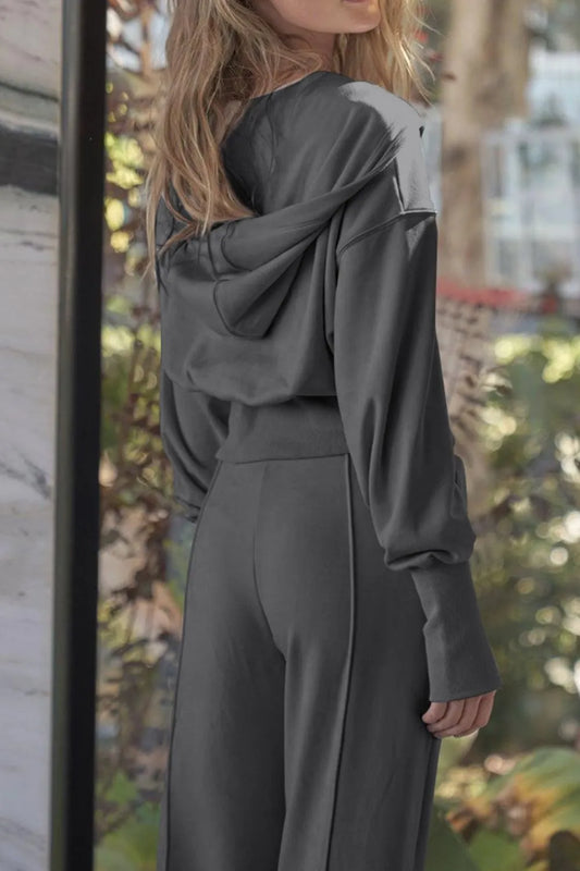 Dark gray zip-up hoodie and jogger pants set with hood, wide cuffs, and drawstring waist